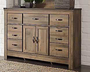 If you love country living, the Trinell bed and dresser with fireplace option match your authentic taste. Rustic finish, plank-style details and nailhead accents pay homage to reclaimed barn wood. The aesthetic is earthy yet clean and sophisticated making for a chic look loaded with charm.Includes panel bed (headboard, footboard, rails) and 7-drawer dresser | Made of engineered wood (MDF/particleboard) and decorative laminate | Warm rustic plank finish over replicated oak grain and authentic touch | Antiqued bronze-tone hardware and nailhead accents | Dresser with smooth-gliding drawers | Dresser with adjustable shelf behind cabinet doors | Foundation/box spring required, sold separately; mattress available, sold separately | Compatible with W100-01 and W100-02 electric fireplace inserts | Simple assembly required for fireplace insert installation: remove back panel to accommodate insert | Safety is a top priority, clothing storage units are designed to meet the most current standard for stability, ASTM F 2057 (ASTM International) | Drawers extend out to accommodate maximum access to drawer interior while maintaining safety | Assembly required | Estimated Assembly Time: 10 Minutes