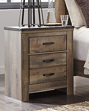 Whether she loves horses or he's a cowboy at heart, the Trinell nightstand matches their authenticity. Rustic finish, plank-style details and nailhead trim pay homage to reclaimed barn wood, making for a chic look loaded with charm. An included charging station for tablets, cellphones and other electronics offers up-to-date convenience.Made of engineered wood (MDF/particleboard) and decorative laminate | Warm rustic plank finish over replicated oak grain and authentic touch | Antiqued bronze-tone hardware | 2 smooth-operating drawers | Nailhead accents | 2 slim-profile USB charging stations | Power cord included; UL Listed | Assembly required