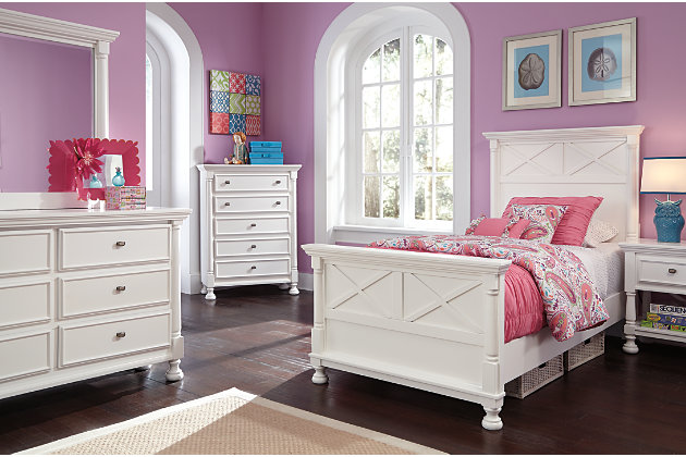 Let your country cottage style shine through with the crisp and cheerful Kaslyn chest of drawers. The clean lines are enhanced with refined details such as classic half-round pilasters and beautifully turned bun feet. Five smooth-gliding drawers easily accommodate your wardrobe needs.Made of veneers, wood and engineered wood | 5 smooth-operating drawers with dovetail construction | Top drawer with felt bottom | Aged nickel-tone hardware | Turned bun feet | Estimated Assembly Time: 15 Minutes
