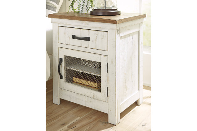 Dreaming of a rustic cottage? Make it a reality with the charming Wystfield nightstand. Distressed vintage white paint finish and black metal hardware exude modern farmhouse vibes. Natural brown top accentuates the wood grain, adding a gorgeous contrast. Door with inset wire mesh houses a shelf behind for extra storage. A stylish look built on quality standards.Made of wood and veneers | Distressed vintage white finish with aged natural pine color top | 1 smooth-gliding drawer; 1 door with inset wire mesh