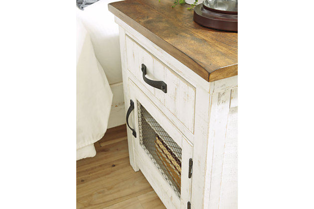 Dreaming of a rustic cottage? Make it a reality with the charming Wystfield nightstand. Distressed vintage white paint finish and black metal hardware exude modern farmhouse vibes. Natural brown top accentuates the wood grain, adding a gorgeous contrast. Door with inset wire mesh houses a shelf behind for extra storage. A stylish look built on quality standards.Made of wood and veneers | Distressed vintage white finish with aged natural pine color top | 1 smooth-gliding drawer; 1 door with inset wire mesh