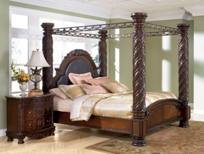 North Shore King Canopy Bed | Ashley Furniture HomeStore - decorative posts and upholstered headboard adorns this king poster bed  paired with matching nightstand