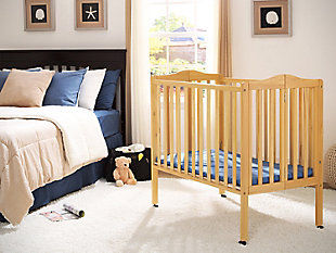 Great for small spaces or as a travel crib, the Portable Folding Crib with Mattress from Delta Children delivers the same versatility and style as a full-size crib, just in a scaled-down size. Its rolling casters allow for easy movement throughout the home, so you can keep your baby nearby at all times. When you’re on the go, it’s easier than ever to provide a safe and comfy sleep space for your little one. Made from durable wood, it folds easily making it perfect for transport. Designed for convenience, the Portable Folding Crib with Mattress from Delta Children includes everything needed for a good night's sleep. Includes mini-crib mattress.For any questions regarding delta children products, please contact consumersupport@deltachildren.com monday to friday, 8:30 a.m. To 6 p.m. (est) | Made of wood, engineered wood and metal | Includes a 2.75" thick mini-crib mattress, uses 24"x 38" crib sheets (sold separately) | Assembly required