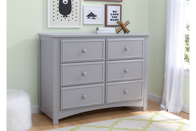 This 6 Drawer Dresser Set from Delta Children is as pretty as it is practical. Featuring six spacious drawers with wooden knobs, this strong and sturdy piece is built to last. The dresser drawers are equipped with a ball-bearing glide system, making it easy for kids to manage on their own. Extra features that ensure your child’s well-being include safety stops that prevent the drawers from falling out, as well as an included anti-tip kit. Add additional functionality to your dresser with the Delta Changing Top. The Changing Top securely attaches to the dresser, offering a dedicated space for changing or dressing your baby. Once your child has outgrown the need for a changing table, the top can easily be removed. Changing pad required (sold separately).Includes Delta 6 Drawer Dresser and Changing Top | Made of wood, engineered wood and metal | Top drawer features a double drawer front that opens to reveal one spacious drawer | 6 smooth gliding drawers with ball-bearing construction and safety stops | Solid wood changing top securely mounts to the dresser, removes easily | Requires a 34" x 16" x 1" changing pad (sold separately)s | Anti-tip kit included | Assembly required | For any questions regarding Delta Children products, please contact consumersupport@deltachildren.com. Monday to Friday, 8:30 a.m. to 6 p.m. (EST)