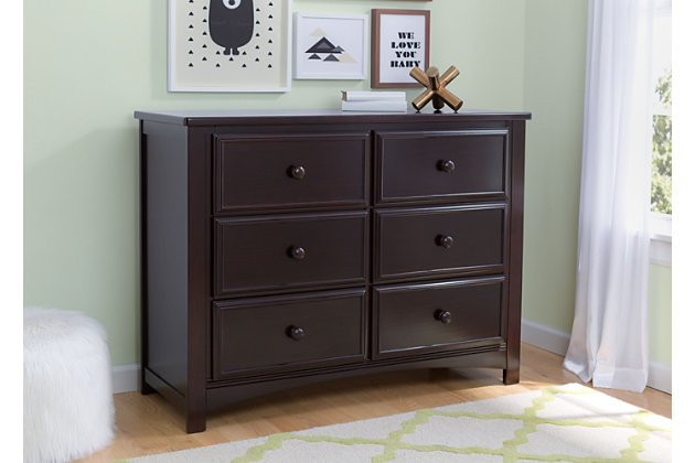 This 6 Drawer Dresser Set from Delta Children is as pretty as it is practical. Featuring six spacious drawers with wooden knobs, this strong and sturdy piece is built to last. The dresser drawers are equipped with a ball-bearing glide system, making it easy for kids to manage on their own. Extra features that ensure your child’s well-being include safety stops that prevent the drawers from falling out, as well as an included anti-tip kit. Add additional functionality to your dresser with the Delta Changing Top. The Changing Top securely attaches to the dresser, offering a dedicated space for changing or dressing your baby. Once your child has outgrown the need for a changing table, the top can easily be removed. Changing pad required (sold separately).Includes Delta 6 Drawer Dresser and Changing Top | Made of wood, engineered wood and metal | Top drawer features a double drawer front that opens to reveal one spacious drawer | 6 smooth gliding drawers with ball-bearing construction and safety stops | Solid wood changing top securely mounts to the dresser, removes easily | Requires a 34" x 16" x 1" changing pad (sold separately) | Anti-tip kit included | Assembly required | For any questions regarding Delta Children products, please contact consumersupport@deltachildren.com. Monday to Friday, 8:30 a.m. to 6 p.m. (EST)
