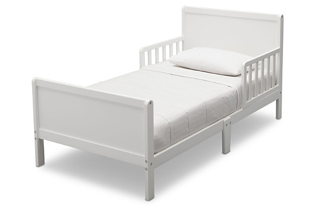 Sweet dreams are made of this. Merging a clean profile with cozy comfort, this toddler bed is high style, sized accordingly. Designed to give them the “big kid” bed they crave while including a few modifications to put you at ease, this bed will have everyone resting easy. Low to the ground profile makes it easy for your little one to get in and out of bed on their own, while the attached guardrails are both pretty and practical. Best of all, your existing full-size crib mattress (sold separately) will fit this toddler bed to a T.For any questions regarding delta children products, please contact consumersupport@deltachildren.com monday to friday, 8:30 a.m. To 6 p.m. (est) | Made of wood | White finish | Transitional design | Fits full-size crib mattress; sold separately | Low profile with guardrails on each side | Assembly required