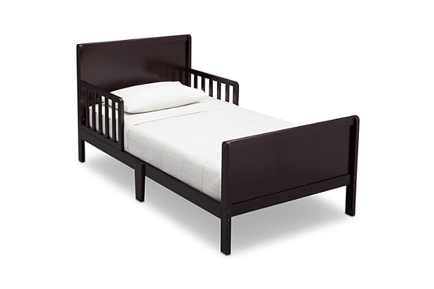 Sweet dreams are made of this. Merging a clean profile with cozy comfort, this toddler bed is high style, sized accordingly. Designed to give them the “big kid” bed they crave while including a few modifications to put you at ease, this bed will have everyone resting easy. Low to the ground profile makes it easy for your little one to get in and out of bed on their own, while the attached guardrails are both pretty and practical. Best of all, your existing full-size crib mattress (sold separately) will fit this toddler bed to a T.For any questions regarding delta children products, please contact consumersupport@deltachildren.com monday to friday, 8:30 a.m. To 6 p.m. (est) | Made of wood | Dark brown finish | Transitional design | Fits full-size crib mattress; sold separately | Low profile with guardrails on each side | Assembly required