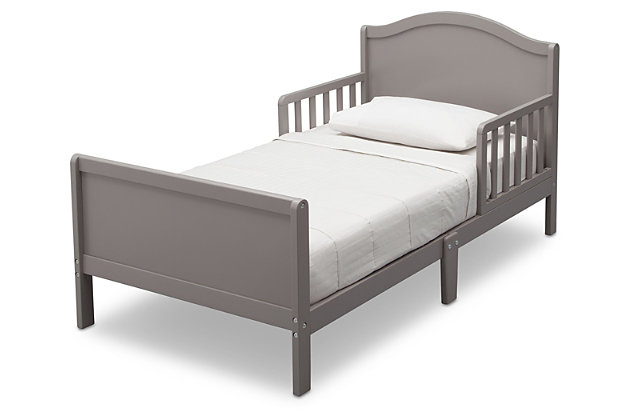 Sweet dreams are made of this. Merging a clean profile with cozy comfort, this toddler bed is high style, sized accordingly. Designed to give them the “big kid” bed they crave while including a few modifications to put you at ease, this bed will have everyone resting easy. Low to the ground profile makes it easy for your little one to get in and out of bed on their own, while the attached guardrails are both pretty and practical. Best of all, your existing full-size crib mattress (sold separately) will fit this toddler bed to a T.For any questions regarding delta children products, please contact consumersupport@deltachildren.com monday to friday, 8:30 a.m. To 6 p.m. (est) | Made of wood | Gray finish | Transitional design | Fits full-size crib mattress; sold separately | Low profile with guardrails on each side | Assembly required