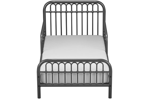 Inspired by classic wrought-iron furniture, the Little Seeds Monarch Hill Ivy metal toddler bed is the perfect size for your growing child. Merging a clean profile with cozy comfort, this toddler bed is high style, sized accordingly. Designed to give them the “big kid” bed they crave while including a few modifications to put you at ease, this bed will have everyone resting easy. Low to the ground profile makes it easy for your little one to get in and out of bed on their own, while the attached guardrails are both pretty and practical. Best of all, your existing -size crib mattress (sold separately) will fit this toddler bed to a T.Made of metal | Non-toxic gray finish | Fits -size crib mattress; sold separately | Low profile with guardrails on each side | Assembly required