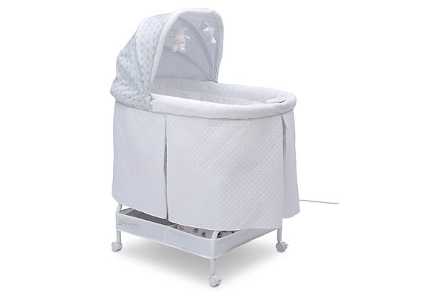 Lull your baby to sleep with the relaxing, automatic gliding movement of the Simmons Kids Silent Auto Gliding Deluxe Bassinet. With a push of a button, the bassinet’s whisper-quiet gliding motion is activated, and the smooth sway of the bassinet will help your newborn drift to sleep peacefully. Outfitted with other electronic features that’ll help Baby power down, this bassinet comes outfitted with preloaded lullabies and sounds, as well as a nightlight—it has everything you need to effortlessly tackle bedtime with your newborn. Built with locking wheels and a lightweight frame to make it easy to move from room to room, this bassinet ensures your little one will have a safe spot to rest in any room of the house—it’s ideal for bedtime or daytime naps with an adjustable canopy that blocks light to create a serene sleep spaceFor any questions regarding delta children products, please contact consumersupport@deltachildren.com monday to friday, 8:30 a.m. To 6 p.m. (est) | Made of metal, plastic and quilted fabric | Holds up to 15 lbs. | Includes fitted sheet, 1" water-resistant pad, music module, nightlight and two plush toys that hang from the canopy | 15-minute intervals of silent, hands-free auto-gliding motion at the push of a button | Ac adapter for battery free operation of glider | 4aa batteries required for the music module and nightlight (not included) | Large storage basket underneath provides ample storage | Locking casters make it easy to move from room-to-room | Jpma certified and meets or exceeds all astm and applicable cpsc standards