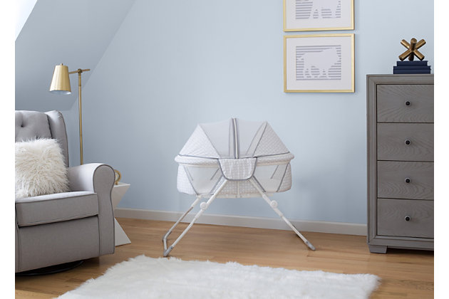 Whether you’re traveling with your baby or in need of a portable sleeper in your home, the EZ Fold Ultra Compact Travel Bassinet from Delta Children makes naptime and bedtime a breeze. The most compact full-size bassinet available, this sleeper ensures your baby has the room they need to rest comfortably while the lightweight design means you can travel without trouble. Easy to setup and store away, the bassinet requires no assembly, and folds flat—the included travel bag makes every outing feel stress-free. Designed with mesh panels on the sides for airflow and increased visibility, this travel bassinet provides the ideal environment for rest and relaxation. A removable canopy protects your little one from curious pets, mosquitos and other insects, and then effortlessly zips off when not needed.Birth to five months; holds up to 15 lbs. | Ultra-compact fold down design with an included travel bag for easy transport or storage; no assembly required | Mesh sides provide added ventilation and increased visibility | Removable canopy keeps baby from curious pets, mosquitos and other insects while creating a cozy sleep space | Includes machine-washable mattress pad | Jpma certified to meet or exceed all safety standards set by the cpsc & astm