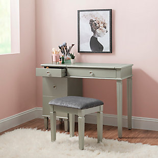 This alluring vanity exudes feminine style and glamorous design. The vanity features a flip top that reveals a hidden mirror and interior storage space. Spacious drawers provide ample storage for accessories, makeup and more. Clear decorative knobs and beaded trim complete the front of the piece. Finished in chic silvertone, this vanity set will easily complement a variety of existing colors. Matching stool is upholstered in a gray polyester fabric. Perfect for a bedroom or dressing area.Includes vanity with hidden mirror and upholstered stool | Made of wood, hardwood and engineered wood with mirrored glass | Silvertone finish with beaded trim | Padded seat with gray polyester upholstery | 3 drawers with clear decorative knobs | Large bottom drawer with salon-style slots for your brushes, curling iron, hairdryer, etc. | Jewelry tray | Some assembly required