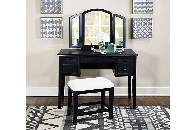 With all the allure of a treasured heirloom—at a fraction of the price—this beguiling 3-piece vanity set will fit right in. A softly padded seat welcomes, while the dark finish and hinged, tri-fold mirror are clear reflections of your good taste. And when you’ve perfected your look, five curved drawers keep the top uncluttered and essentials close at hand.Includes vanity, mirror and stool | Made of rubberwood and engineered wood | Foam cushioned seat with cotton/polyester upholstery | Hinged tri-fold mirror | 5 curved drawers | Assembly required