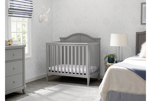 We know not every nursery has an abundance of space, that’s why we created the Delta Children Mini Convertible Baby Crib with Mattress and 2 Sheets set. A timeless silhouette with a bell-shaped headboard and fluted posts, this mini crib offers a classic look in the ideal size for smaller nurseries—without skimping on style, safety or comfort. Small but mighty, this baby crib features a two-position mattress support that can be lowered as your baby grows, plus it easily converts into a twin bed when your child is ready (conversion kit sold separately).Includes mini crib, mattress and 2 fitted crib sheets | Made of wood, engineered wood and metal | Gray finish | 2 fitted crib sheets (light gray, light beige) | Converts from crib to: twin bed with headboard or twin bed with headboard and footboard (bed frame and footboard each sold separately) | Adjustable height mattress support with 2 convenient positions to grow with your baby | Includes mini size crib mattress | Assembly required | Delta children cribs are jpma certified, and are tested above and beyond industry standards | For any questions regarding delta children products, please contact consumersupport@deltachildren.com monday to friday, 8:30 a.m. To 6 p.m. (est)