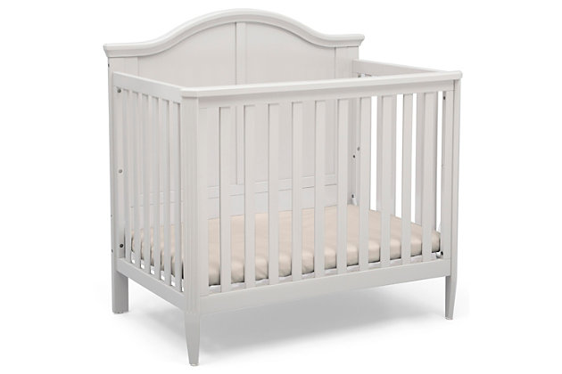 We know not every nursery has an abundance of space, that’s why we created the Delta Children Mini Convertible Baby Crib with Mattress and 2 Sheets set. A timeless silhouette with a bell-shaped headboard and fluted posts, this mini crib offers a classic look in the ideal size for smaller nurseries—without skimping on style, safety or comfort. Small but mighty, this baby crib features a two-position mattress support that can be lowered as your baby grows, plus it easily converts into a twin bed when your child is ready (conversion kit sold separately).Includes mini crib, mattress and 2 fitted crib sheets | Made of wood, engineered wood and metal | White finish | 2 fitted crib sheets (light gray, light beige) | Converts from crib to: twin bed with headboard or twin bed with headboard and footboard (bed frame and footboard each sold separately) | Adjustable height mattress support with 2 convenient positions to grow with your baby | Includes mini size crib mattress | Assembly required | Delta children cribs are jpma certified, and are tested above and beyond industry standards | For any questions regarding delta children products, please contact consumersupport@deltachildren.com monday to friday, 8:30 a.m. To 6 p.m. (est)