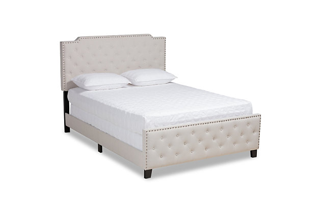 Sweet dreams await with this bed. Crafted with a sturdy wood frame, it’s upholstered in an elegant linen-like fabric and padded with foam for the utmost relaxation. Glamorous silvertone nailheads accentuate the headboard and footboard silhouettes, while button tufting lends a regal look.Made of wood, engineered veneer and engineered wood | Polyester faux linen upholstery with button tufting | Silvertone nailhead accents | Foundation/box spring required, sold separately | Mattress available, sold separately | Assembly required