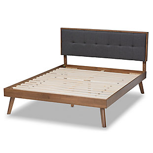 Create the chic, modern bedroom of your dreams with this bed. Built with a sturdy wood frame, it features a low platform finished in a warm walnut-tone. The headboard is upholstered in a soft, foam-filled fabric set within a wooden frame for a tailored look. Biscuit tufting lends dimension and elegance, while splayed legs create a cool, retro profile.Made of wood and engineered wood | Polyester upholstered headboard with button tufting | Brown walnut-tone finish | Slats eliminate the need for a box spring | Assembly required