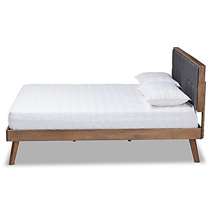 Create the chic, modern bedroom of your dreams with this bed. Built with a sturdy wood frame, it features a low platform finished in a warm walnut-tone. The headboard is upholstered in a soft, foam-filled fabric set within a wooden frame for a tailored look. Biscuit tufting lends dimension and elegance, while splayed legs create a cool, retro profile.Made of wood and engineered wood | Polyester upholstered headboard with button tufting | Brown walnut-tone finish | Slats eliminate the need for a box spring | Assembly required