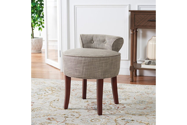This delightful, round vanity chair is pretty and petite enough to tuck in a bathroom or bedroom and brimming with feminine style. Graceful wood legs, deep seat, sophisticated colored fabric and diminutive button tufted back are designed for indulgent comfort. This vanity stool is a charming seat suited for various types of decor.Viscose/polyester upholstery | High-resiliency foam cushions wrapped in thick poly fiber | Birch wood legs with cherry mahogany finish | Assembly required