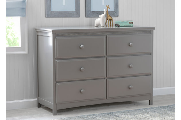 Classic styling and pearl detailing give the Emerson 6 Drawer Dresser by Delta Children a timeless quality. Equipped with six sliding drawers that feature safety stops to prevent the drawers from falling out, this dresser offers a wealth of storage space. Its beautiful finish will never go out of style, while its sturdy wood construction makes it as durable as it is attractive. Round drawer pulls provide a charming finishing touch. A great piece for the nursery, your kid's bedroom or your master bedroom, The Emerson is the smart choice for storage in any space. The Emerson 6 Drawer Dresser is part of the Emerson nursery collection. Pair with the Emerson 4-in-1 Convertible Crib for a coordinated look. Coordinating collection pieces each sold separately. All Delta Children dressers and chests meet the requirements of ASTM F2057, the voluntary industry tip over standard for dressers. For your children's safety, only purchase dressers that comply with this standard. For additional security, Delta strongly recommends that all dressers in your home be anchored; all Delta dressers include a wall anchor. To learn how to properly secure your dresser, please see the product assembly instructions or visit our website.6 drawers offer plenty of storage space | Drawers feature metal drawer guides with safety stops for years of worry-free use | Strong & sturdy wood construction | Engineered and tested to meet astm furniture safety standards; tested for lead and other toxic elements to meet or exceed astm safety standards; includes tipover restraint | Assembled dimensions: 47.50" w x 20.25" d x 34" h | Assembly required | For any questions regarding delta children products, please contact consumersupport@deltachildren.com monday to friday, 8:30 a.m. To 6 p.m. (est)