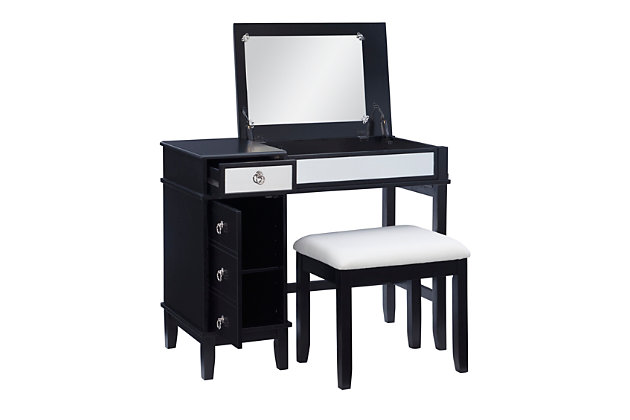 This chic vanity set in black with a mirrored front embodies the holy trinity of style, storage, and functionality. The desk top flips open on soft close hinges to reveal an oversized 19.75” x 13.5” mirror, while the front panel folds down into the perfect work station for a laptop or keyboard. A drawer on the top left side sits above a storage cabinet with an adjustable shelf. The set also includes a matching vanity bench with a padded cushion adorned with white polyester linen look fabric that has a hint of silver thread running interwoven.Top panel opens to reveal oversized 19.75” x 13.5” mirror and extra storage space | Magnetized front panel folds down to make the perfect workspace for a laptop or keyboard | A drawer and storage cabinet with adjustable shelf offer ample storage | Convenient cable management in back panel helps to avoid tangling | Multiple configurations to fit the needs of your day | Matching vanity bench with padded seat | Soft close hinges allow for safe and smooth open and close | Supports up to 250 lbs. | Assembly required