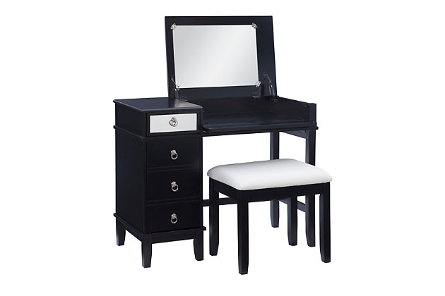 This chic vanity set in black with a mirrored front embodies the holy trinity of style, storage, and functionality. The desk top flips open on soft close hinges to reveal an oversized 19.75” x 13.5” mirror, while the front panel folds down into the perfect work station for a laptop or keyboard. A drawer on the top left side sits above a storage cabinet with an adjustable shelf. The set also includes a matching vanity bench with a padded cushion adorned with white polyester linen look fabric that has a hint of silver thread running interwoven.Top panel opens to reveal oversized 19.75” x 13.5” mirror and extra storage space | Magnetized front panel folds down to make the perfect workspace for a laptop or keyboard | A drawer and storage cabinet with adjustable shelf offer ample storage | Convenient cable management in back panel helps to avoid tangling | Multiple configurations to fit the needs of your day | Matching vanity bench with padded seat | Soft close hinges allow for safe and smooth open and close | Supports up to 250 lbs. | Assembly required