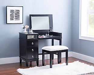 This chic vanity set in black with a mirrored front embodies the holy trinity of style, storage, and functionality. The desk top flips open on soft close hinges to reveal an oversized 19.75” x 13.5” mirror, while the front panel folds down into the perfect work station for a laptop or keyboard. A drawer on the top left side sits above a large storage cabinet with an adjustable shelf. The set also includes a matching vanity bench with a padded cushion adorned with white polyester linen look fabric that has a hint of silver thread running interwoven.Top panel opens to reveal oversized 19.75” x 13.5” mirror and extra storage space | Magnetized front panel folds down to make the perfect workspace for a laptop or keyboard | A drawer and large storage cabinet with adjustable shelf offer ample storage | Convenient cable management in back panel helps to avoid tangling | Multiple configurations to fit the needs of your day | Matching vanity bench with padded seat | Soft close hinges allow for safe and smooth open and close | Supports up to 250 lbs. | Assembly required