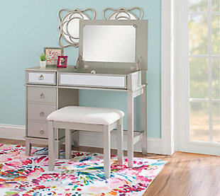 This chic vanity set in silver with a mirrored front embodies the holy trinity of style, storage, and functionality. The desk top flips open on soft close hinges to reveal an oversized 19.75” x 13.5” mirror, while the front panel folds down into the perfect work station for a laptop or keyboard. A drawer on the top left side sits above a large storage cabinet with an adjustable shelf. The set also includes a matching vanity bench with a padded cushion adorned with white polyester linen look fabric that has a hint of silver thread running interwoven.Top panel opens to reveal oversized 19.75” x 13.5” mirror and extra storage space | Magnetized front panel folds down to make the perfect workspace for a laptop or keyboard | A drawer and large storage cabinet with adjustable shelf offer ample storage | Convenient cable management in back panel helps to avoid tangling | Multiple configurations to fit the needs of your day | Matching vanity bench with padded seat | Soft close hinges allow for safe and smooth open and close | Supports up to 250 lbs. | Assembly required