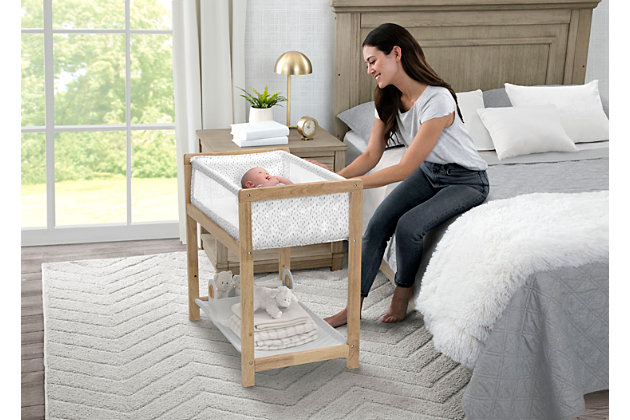 Enjoy peaceful moments from naptime to nighttime with the Classic Wood Bedside Bassinet Sleeper by Delta Children. It features a solid wood frame and gender-neutral pattern that complements any décor. A safe and comfortable place to sleep anywhere in your home, this bassinet is lightweight enough to be easily moved from room to room. Mesh sides allow generous airflow and a large storage shelf keeps necessities within reach. This bassinet is recommended for babies 0-5 months. Max weight 30 lbs. Stop use at 5 months or once your infant begins to push up on their hands and knees, whichever comes first.   Delta Children was founded around the idea of making safe, high-quality children's furniture affordable for all families. They know there's nothing more important than safety when it comes to your child's space. That's why all Delta Children products are built with long-lasting materials to ensure they stand up to years of use. Plus, they are rigorously tested to meet or exceed all industry safety standards.Keeps baby close: this timeless baby bassinet with solid wood base and legs keeps baby safely by your bedside;  neutral design is ideal for boys or girls; made of sustainable new zealand pine wood | Airflow mesh: breathable mesh on sides promote airflow and cooler sleep environment for baby | Tons of storage: large storage shelf under the frame keeps baby’s necessities within reach | Size: assembled dimensions: 33”l x 20.5”w x 32“h; bassinet includes 1-inch waterproof mattress pad and fitted bassinet sheet | We put your baby's safety first: jpma certified to meet or exceed all safety standards set by the cpsc and astm; we know chemicals have no place in your nursery, so we use a non-toxic multi-step painting process that is lead and phthalate safe