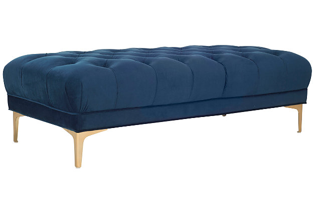 Create an instant oasis in your living room with this decadent tufted rectangular bench. Extravagant yet versatile, its sumptuous velvet upholstery is paired with a classic brass-tone finish on chic modern legs. Use it as a coffee table or extra seating with a truly contemporary touch.Made with iron | Upholstered in navy tufted velvet over cushioned seat | Brass-tone finish |  assembly required