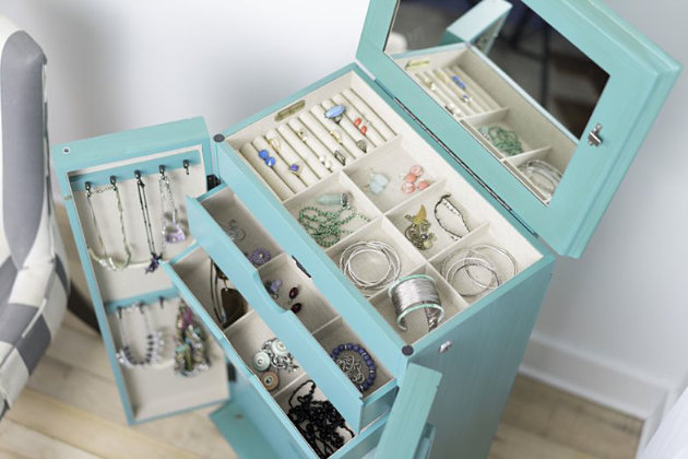 Have you been looking for a fully locking jewelry armoire…well you have found it. The Cabby Jewelry Armoire is the kind of furniture piece that makes you excited to get dressed up. Not only is it pretty to have around, this jewelry storage solution neatly organizes all the accessories you own, like necklaces, earrings, rings, and more. The rich turquoise color is complemented by an antiqued finish, and the inside is fully lined in an attractive natural linen. The French-style doors with bronze hardware open to reveal seven divided storage drawers. On the top, the hinged lid lifts to a convenient mirror and more storage. On the side, you’ll find 16 necklace hooks. This jewelry armoire has so much space inside, your storage is endless.Made with wood | Lined with linen | Top lid lifts to reveal additional storage, ring rolls and a full frame mirror | 7 storage drawers; 3 drawers with divided compartments, 4 drawers include open storage | 16 necklace hooks on sides of doors | Assembly required