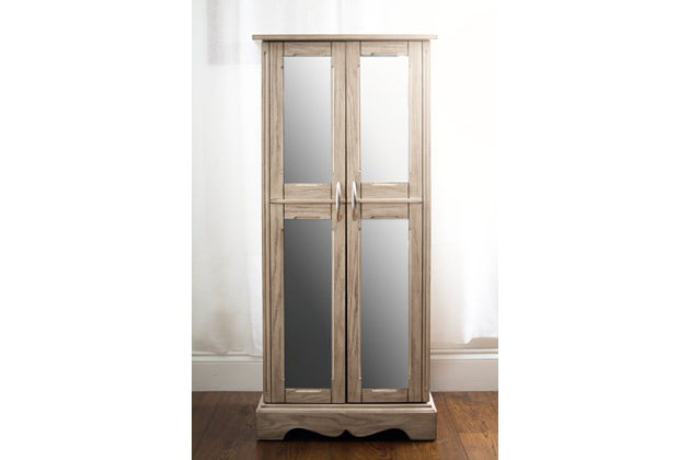 If your style is refined, but you adore a touch of rustic character, then the Chelsea Standing Jewelry Armoire is your perfect match. The taupe mist finish beautiy accentuates the natural wood grain, while the sleek design, polished hardware and mirrored, French-style doors add modern appeal. 7 spacious pull-out drawers await behind the double doors, each one lined with an anti-tarnish felt that protects your pieces from harm. A variety of storage configurations ensure that there’s a place for everything, while 16 jewelry hooks keeps your necklaces neatly tucked away and tangle free. Lift the lid, and you’ll find a vanity mirror, ring rolls, additional storage and a cord management hole that keeps cables at bay as your devices charge. There’s so much room within the Chelsea Standing Jewelry Armoire that you may need to buy more accessories just to fill it all!Made with wood | French style doors with mirror front | Divided compartments lined with anti-tarnish felt | 7 drawers | 16 necklace hooks and ring rolls | Assembly required
