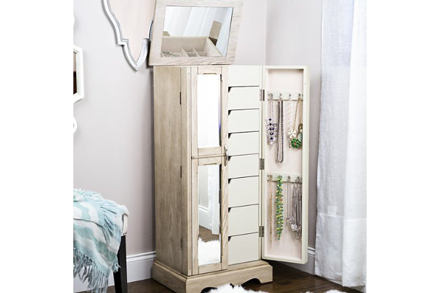 If your style is refined, but you adore a touch of rustic character, then the Chelsea Standing Jewelry Armoire is your perfect match. The taupe mist finish beautifully accentuates the natural wood grain, while the sleek design, polished hardware and mirrored, French-style doors add modern appeal. 7 spacious pull-out drawers await behind the double doors, each one lined with an anti-tarnish felt that protects your pieces from harm. A variety of storage configurations ensure that there’s a place for everything, while 16 jewelry hooks keeps your necklaces neatly tucked away and tangle free. Lift the lid, and you’ll find a vanity mirror, ring rolls, additional storage and a cord management hole that keeps cables at bay as your devices charge. There’s so much room within the Chelsea Standing Jewelry Armoire that you may need to buy more accessories just to fill it all!Made with wood | French style doors with mirror front | Divided compartments lined with anti-tarnish felt | 7 drawers | 16 necklace hooks and ring rolls | Assembly required