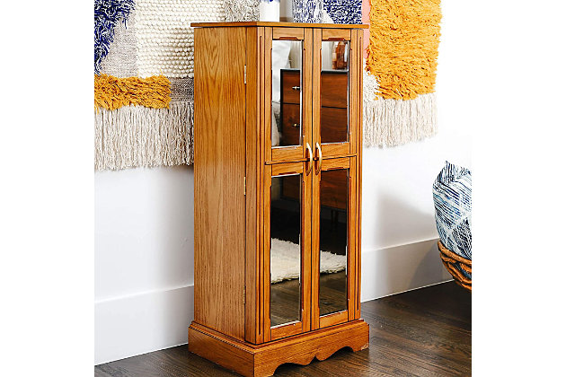 Behind every attractive woman is a little bit of mystery. (Like, how in the world does she organize all her accessories?!) The Chelsea Jewelry Armoire can be your little secret to achieving that enigma. The mirrored doors and inside vanity mirror combined with the abundance of storage space makes getting ready a cinch. The walnut finish, French doors, and polished hardware give this storage solution an alluring appeal. Its organizational abilities are pretty straightforward—handy divided compartments on top and inside each of the seven drawers and 16 necklace hooks on each side. The anti-tarnish felt lining ensures your prized possessions are kept preserved and pristine. Take the stress out of looking your best with this jewelry storage armoire.Made with wood | Top lid opens to reveal a vanity mirror and cord management hole | Both front mirrored doors open to display 8 necklace hooks on each | 7 drawers | Interior is lined with plush felt | Assembly required