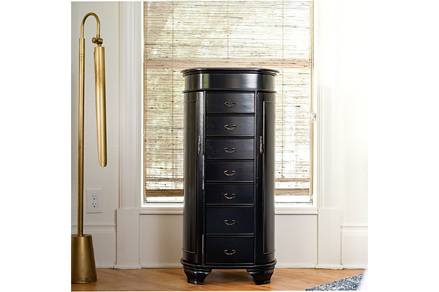 Hives & Honey’s Daley Oval Standing Jewelry Armoire is a one-of-a-kind piece! Designed with tradition in mind, this stylish armoire also has a modern touch with the rounded edges. The Daley Jewelry Armoire will store your entire jewelry collection with ease; all drawers are lined with an anti-tarnish felt. Available in three colors: cherry, black, & turquoise. Item Dimensions: 38″ H x 16″ W x 12.5″ DMade with wood | Fully lined with anti-tarnish felt | 7 pull out drawers with various storage configurations | 2 side panels open with necklace hooks in each | Assembly required