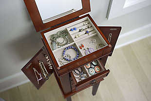 Accent your bedroom with this walnut armoire for a beautiful and classic look. Perfect for a young woman just getting her jewelry collection started. There is enough storage to organize all of your favorite items. Easily access the top compartment with a hinged lid, which open to display ring rolls, compartments and a vanity mirror. With this armoire you’ll be ready for any occasion!Made with wood | Finished in walnut | Five drawers for storage; two with divided compartments | Two side panels with 3 necklace hooks in each | The top of the armoire is hinged and opens up to reveal a vanity mirror | Assembly required