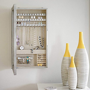 Mirror, mirror on the wall, who’s the fairest of them all? Well the answer to that would have to be the Jamie Mirror Frame. Not only is this mirror gorgeous with its stunning, antiqued silver frame, it is also a functional storage cabinet designed to house your favorite jewelry pieces. Open the hinged door, and you’ll find earring bars, necklace hooks, ring rolls, and a bracelet bar. Additional divided storage compartments are the ideal place for keeping your lipstick and mascara, making the Jamie Jewelry Storage Mirror Frame the perfect companion to your beautification routine.Made with wood | Inside lined with a anti-tarnish linen | 25 earring hooks | 10 necklace hooks | 7 divided compartments | Bracelet bar and ring rolls | Includes mounting hardware