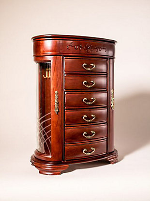 Well, hello there, little beauty. You’ll say that every time you walk up to the Patricia Jewelry Cabinet (and when you look in the mirror, just inside the top lid). And what a little beauty it is with the rich antiqued mahogany finish, antiqued brass drawer pulls, rounded design, and etched floral flourishes. A top hinged lid opens to reveal 10 ring rolls and 4 divided compartments. Two etched glass doors hold necklace hooks and more storage. The six spacious drawers provide the perfect spot for bracelets, watches, necklaces, or other jewelry.Made with wood | Fully lined with anti-tarnish felt | 6 drawers | Hinged lid opens to a vanity mirror, 10 ring rolls and 4 divided compartments | Assembly required