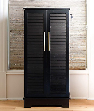 Showcase your lovely baubles or a collection of statement necklaces in this alluring jewelry armoire. Crafted with solid wood veneers, it offers a traditional sturdy silhouette with an contemporary style featuring two shutter doors with gold hardware. Easily tuck away your accessories in the seven pull out drawers with divided compartments and anti-tarnish felt linen.Made with wood | Anti-tarnish felt linen | Full locking | Goldtone hardware | 7 drawers that offer divided compartments and open storage | Vanity mirror | Assembly required
