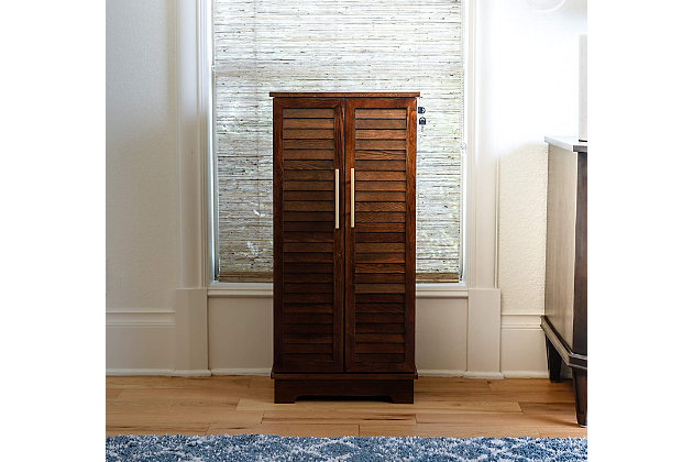 Showcase your lovely baubles or a collection of statement necklaces in this alluring jewelry armoire. Crafted with solid wood veneers, it offers a traditional sturdy silhouette with an contemporary style featuring two shutter doors with gold hardware. Easily tuck away your accessories in the seven pull out drawers with divided compartments and anti-tarnish felt linen.Made with wood | Anti-tarnish felt linen | Full locking | Goldtone hardware | 7 drawers that offer divided compartments and open storage | Vanity mirror | Assembly required