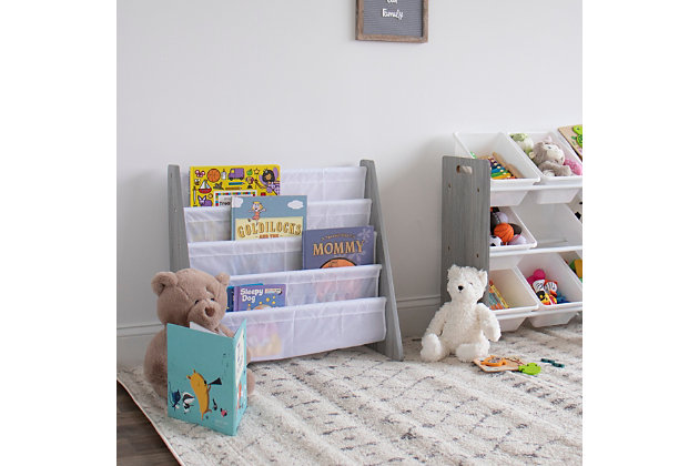 The space-saving, toddler-sized Humble Crew Kids Bookshelf 4 Tier Book Organizer is the perfect storage solution for your little one's favorite collection of books. Our bookcase displays books with covers facing forward, making identification and retrieval easy for children. This bookrack features a beautiful grey wood finish and four deep fabric storage pockets in white for reading books, board books, coloring books and magazines of all shapes and sizes. This space-saving bookshelf is sized just right for your toddler and is ideal for children aged 3 and up.  Made with sturdy engineered wood construction, it is easy to assemble and clean. All hardware is included. Assembled dimensions: 25" W x 11" D x 24" HToddler-sized kid's bookshelf displays books with covers facing forward for easy identification. | Four deep fabric storage pockets stow reading books, board books, coloring books and magazines of all shapes and sizes | Sturdy engineered wood construction is easy to assemble and clean.  includes all hardware. | Ideal for children aged 3 and up | Space-saving design. Assembled dimensions: 25"w x 11"d x 24"h | Neutral compact design fits into any room or environment.