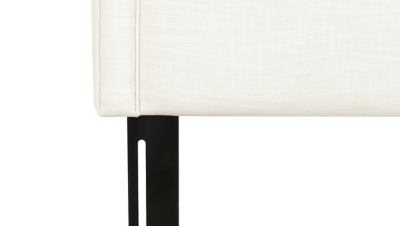 Close-up of the upholstered headboard leg and fabric