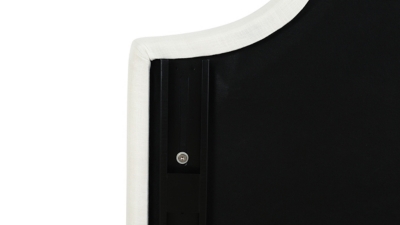 Close-up of metal leg with slot holes on white upholstery
