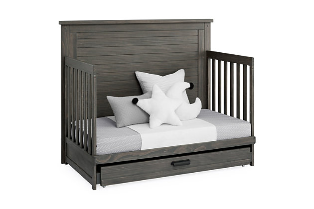 The Caden 6-in-1 Convertible Crib with Trundle Drawer by Simmons Kids is designed with lasting, farmhouse style. The crib's softy textured finish is hand-applied for a rustic look while the included trundle drawer adds additional functionality with space to store extra blankets and other bed linens. Plus, it will accommodate your baby from birth through their teenage years. This crib's grow-with-me design features three adjustable height levels that allow the crib to be lowered as your child begins to stand, and it converts from a crib to a toddler bed, sofa, daybed and size bed with headboard and footboard or headboard only. Available in Rustic gray, Rustic Mist and Rustic Acorn. Daybed Rail and Trundle included; Toddler Guardrail, Size Bed Rails sold separately. Producing the finest furniture for over 80 years, Simmons Kids has always been committed to the safety of every family. All Simmons Kids cribs are JPMA certified, are rigorously tested to meet or exceed all industry safety standards.SAFE OPTION FOR YOUR BABY: This crib is JPMA certified to meet or exceed all safety standards set by the CPSC and ASTM. We know chemicals have no place in your nursery, so we use a non-toxic multi-step painting process that is lead and phthalate safe | 6-IN-1 CONVERTIBLE CRIB WITH TRUNDLE: Crib converts to a toddler bed, daybed, sofa, bed with headboard and footboard and to a bed with headboard only (Daybed rail included). Included under crib trundle storage drawer features 4 wheels for easy operation | FARMHOUSE FINISH: Crib is available in Rustic gray, Rustic Mist or Rustic Acorn. The softy textured finish is hand applied. Due to varying grains and natural variations in the wood, no two pieces are exactly alike | ADJUSTABLE HEIGHT: Adjustable height mattress support with 3 convenient positions to grow with your baby. ACCESS RAIL DIMENSIONS: From Floor: 36.25"; From Top Mattress Support Position: 17.5"; From Bottom Mattress Support Position: 27.75" | COORDINATING ITEMS: Pair with any Delta Children Dresser in the same color, for the perfect baby nursery. Uses a standard size crib mattress (sold separately). To ensure the perfect fit pair your crib with a Delta Children, Serta, Beautyrest or Simmons Kids crib mattress