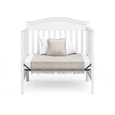 Crib styled with blanket and pillows
