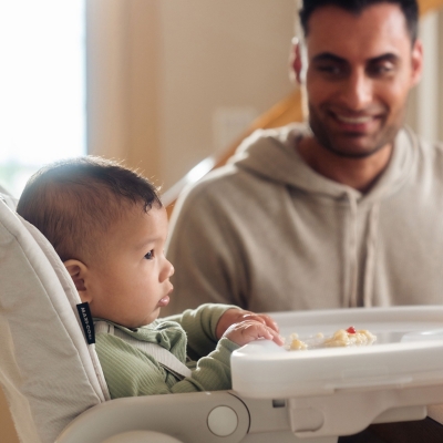 Child in high chair with caregiver