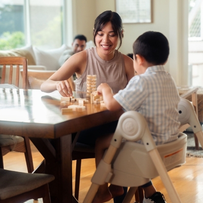 Family playing at table with child in high chair
