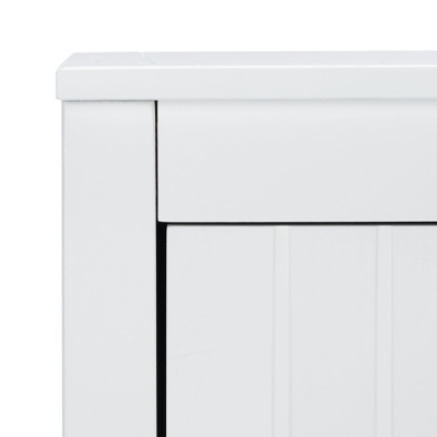 Back or front view of a brass circular drawer pull mounted on a white paneled cabinet.
