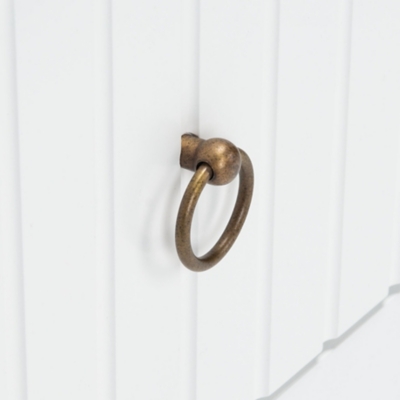 Corner joint of white furniture with visible panel edge and a small screw hole.