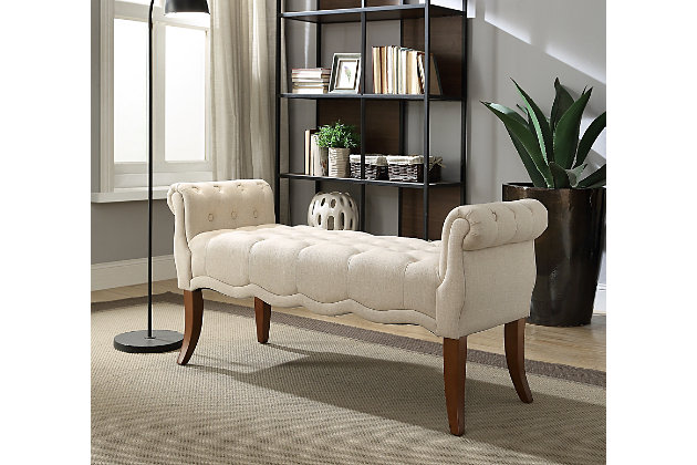 Sporting flared legs, roll arms, deep tufting and sweet scalloped details, the Erika upholstered roll bench charms with a sense of tradition and romance. What a pretty, practical choice for added seating in a hallway, entry or at the foot of the bed. Rest assured, this upholstered bench in light beige is crafted with durable hardwood for years of satisfaction.Made with solid wood | Light beige polyester upholstery | Tufted seat | Ca fire foam cushion | Exposed legs with dark walnut-tone finish | Assembly required